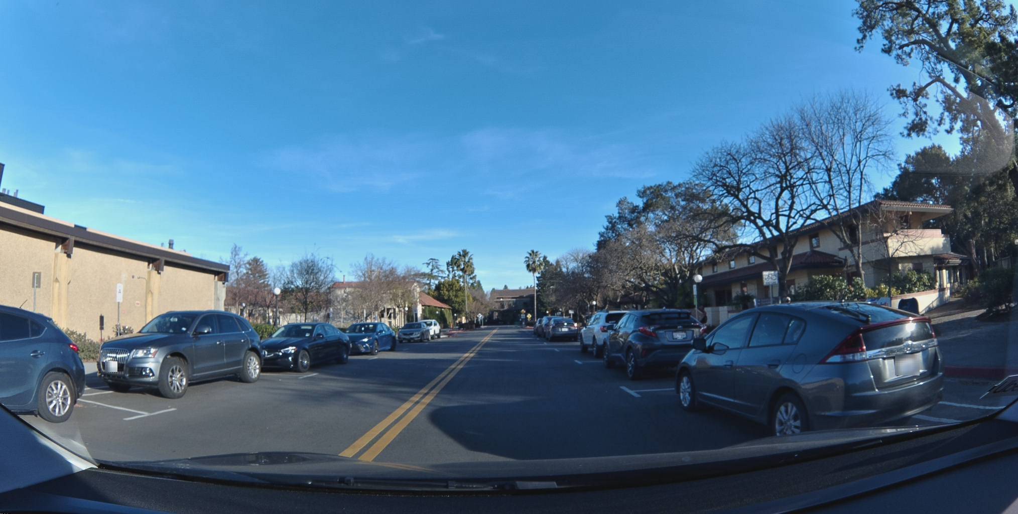 Privacy blurring example showing blurred license plates on parked vehicles